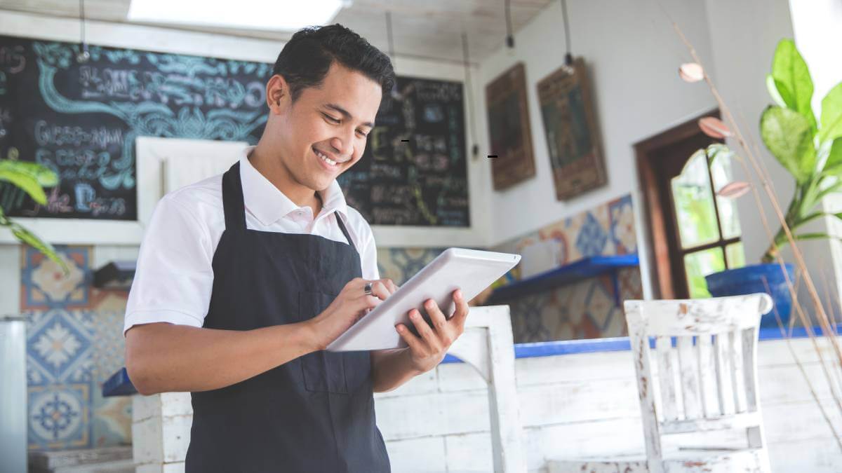 Restaurant Owner On Tablet