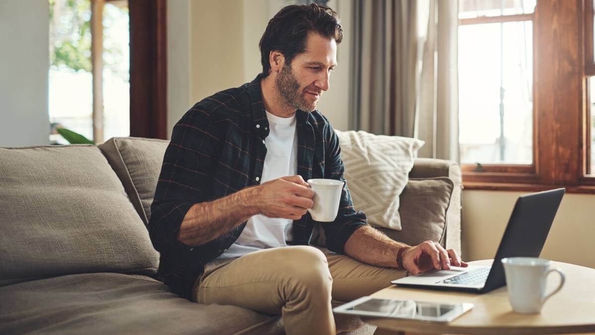 Man On Laptop On The Sofa